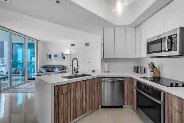 a kitchen with a sink stove and microwave