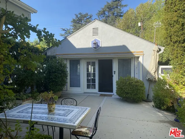 a front view of house with a garden and patio