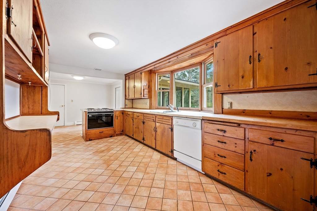 14 Somerset Road Lexington, MA 02420 - Photo 12 of 42 a large kitchen with stainless steel appliances wooden cabinets a stove and a refrigerator