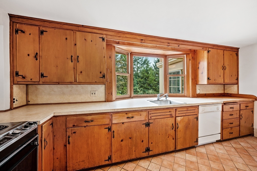 14 Somerset Road Lexington, MA 02420 - Photo 13 of 42 a kitchen with wooden cabinets and sink