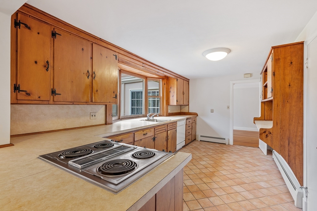 14 Somerset Road Lexington, MA 02420 - Photo 14 of 42 a kitchen with a stove and a refrigerator