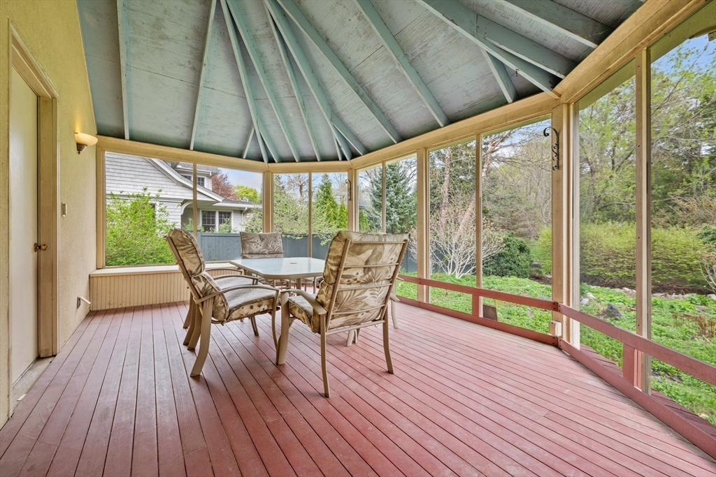 14 Somerset Road Lexington, MA 02420 - Photo 20 of 42 a view of a patio with table and chairs under an umbrella with wooden floor