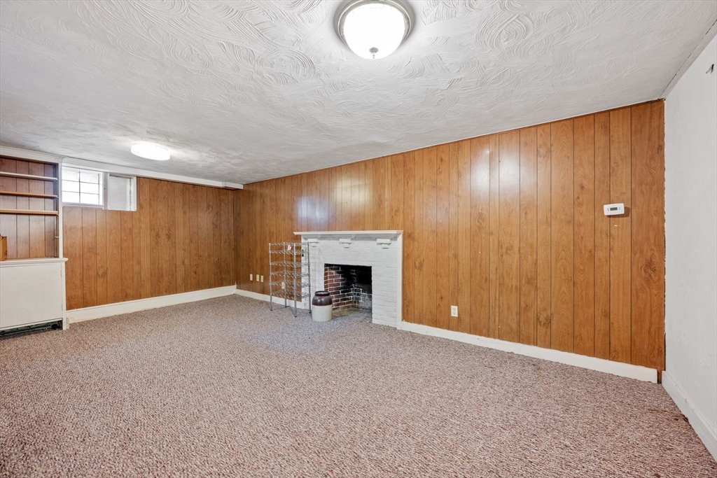 14 Somerset Road Lexington, MA 02420 - Photo 39 of 42 a view of an empty room with a fireplace