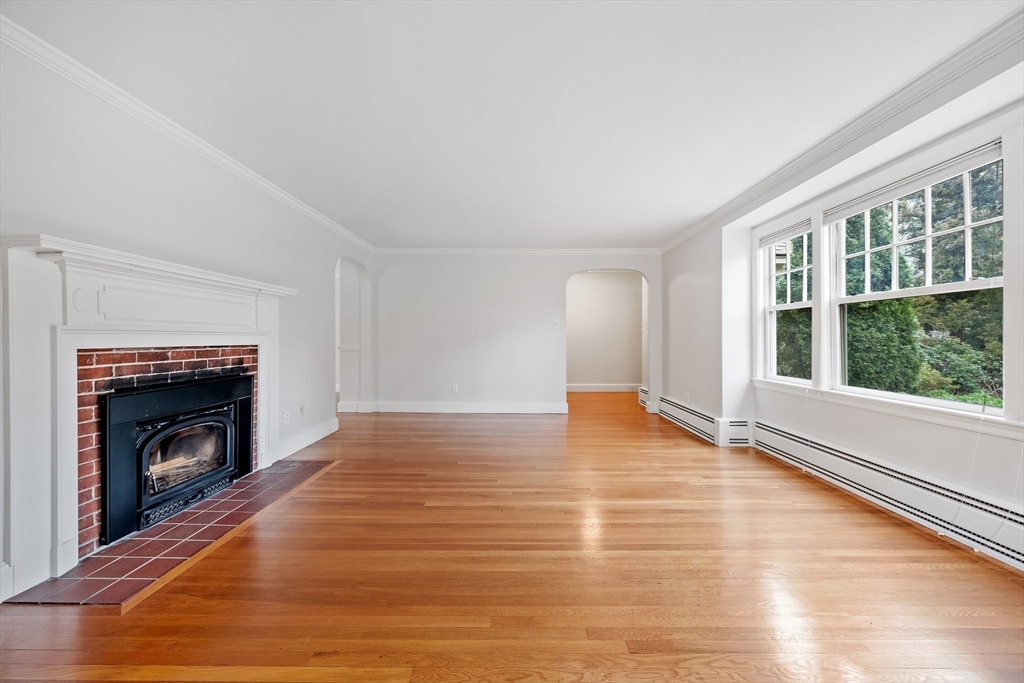 14 Somerset Road Lexington, MA 02420 - Photo 4 of 42 a view of empty room with wooden floor and fireplace