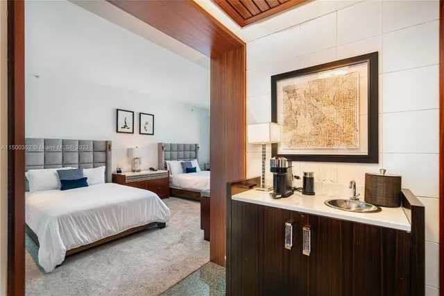 a bedroom with two beds and a large window