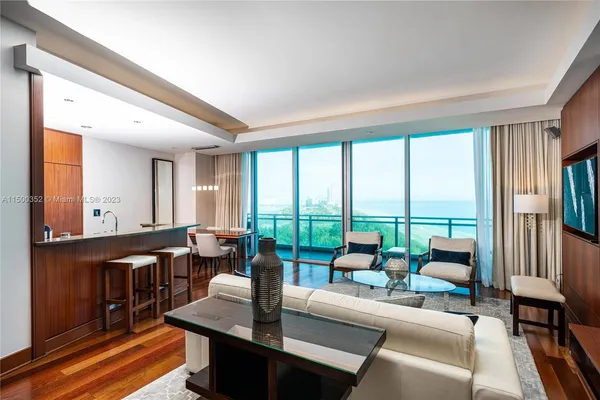 a living room with furniture and large windows