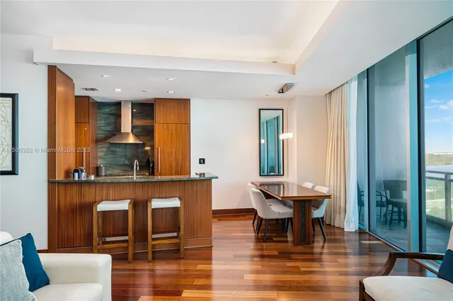 a living room with fireplace furniture and a large window