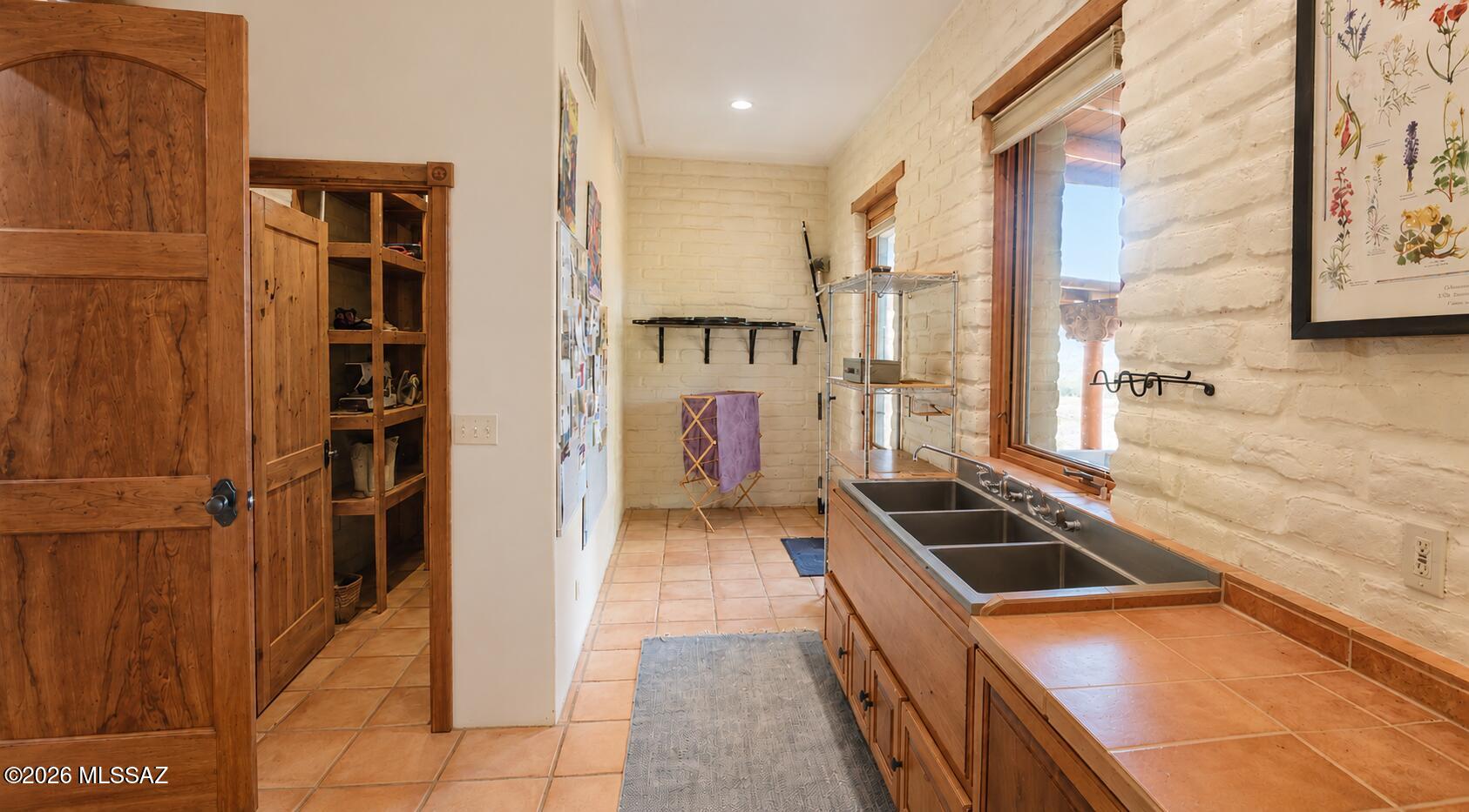 15791 East Hillton Ranch Road Vail, AZ 85641 - Photo 19 of 47 Huge walk in pantry and untility room with triple sink . Double doors exit to back covered porch