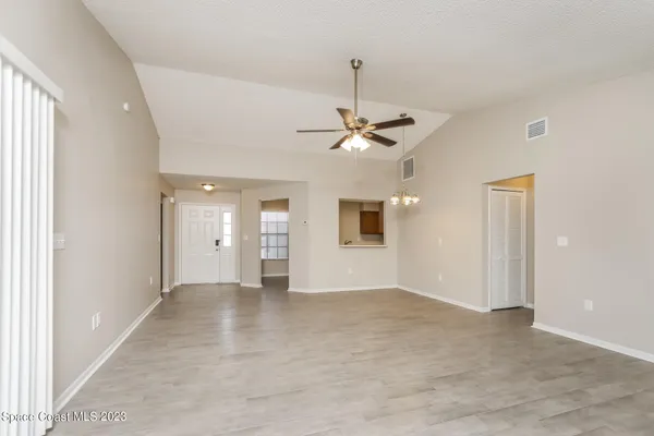 a view of an empty room with a chandelier