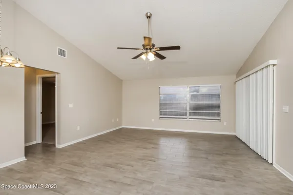 a view of a room with a ceiling fan and a window