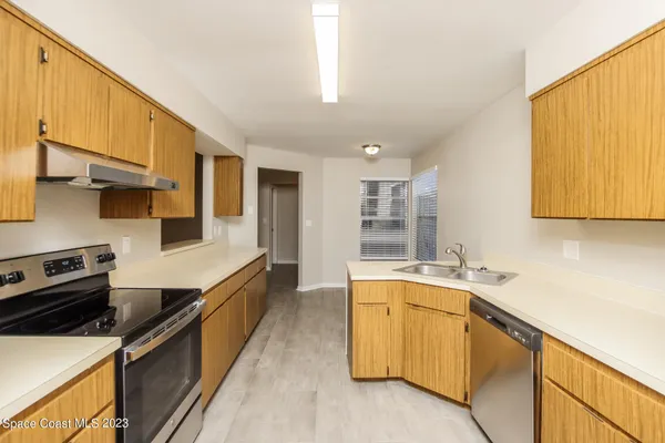 a kitchen with a sink and wooden cabinets