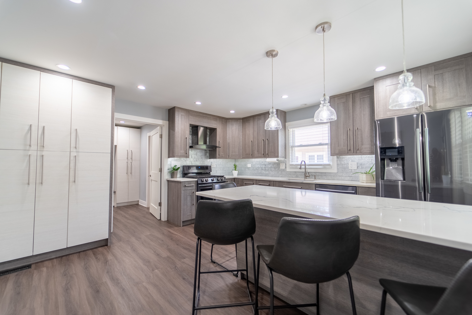 118 East North Avenue Addison, IL 60101 - Photo 15 of 50 a large kitchen with kitchen island a large counter top space a sink stainless steel appliances and cabinets
