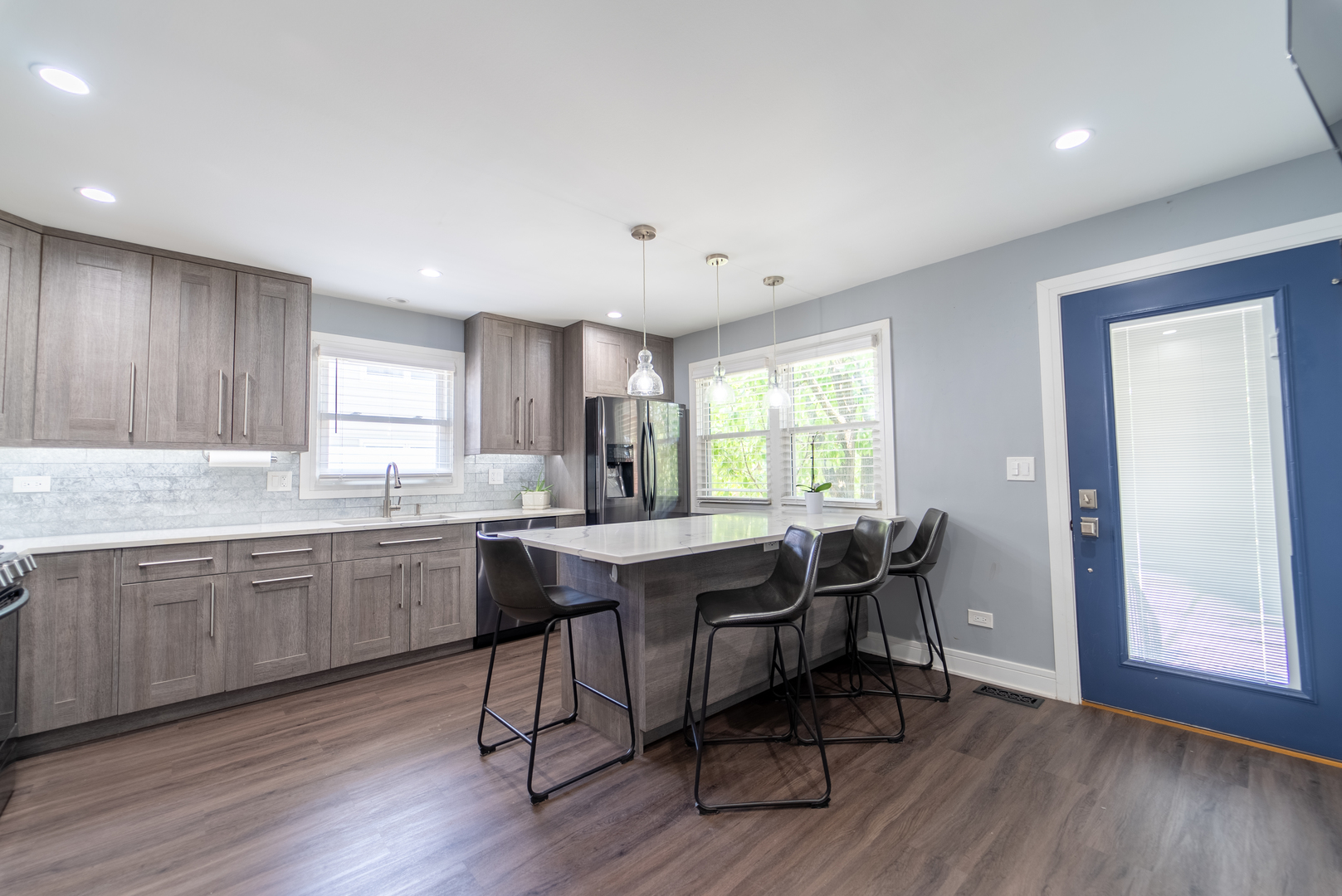 118 East North Avenue Addison, IL 60101 - Photo 16 of 50 a kitchen with granite countertop a table chairs sink and wooden floor