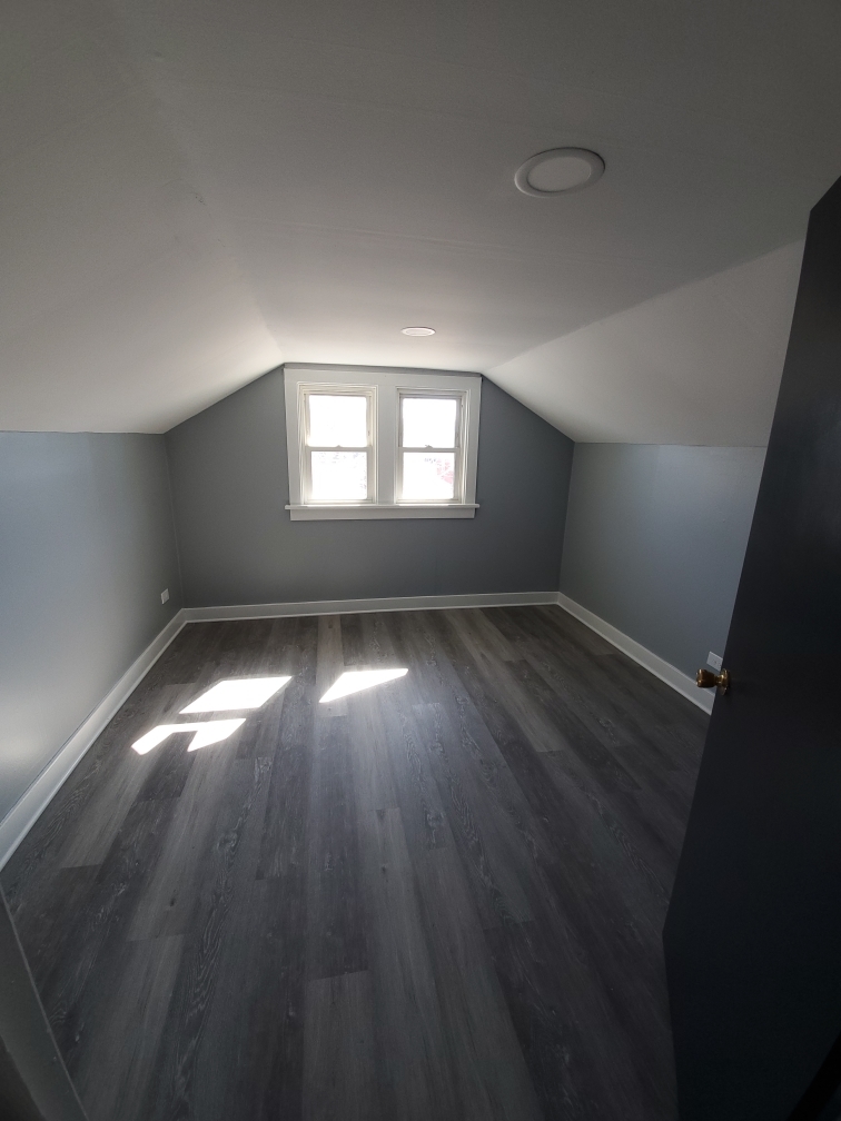 118 East North Avenue Addison, IL 60101 - Photo 35 of 50 an empty room with wooden floor and windows