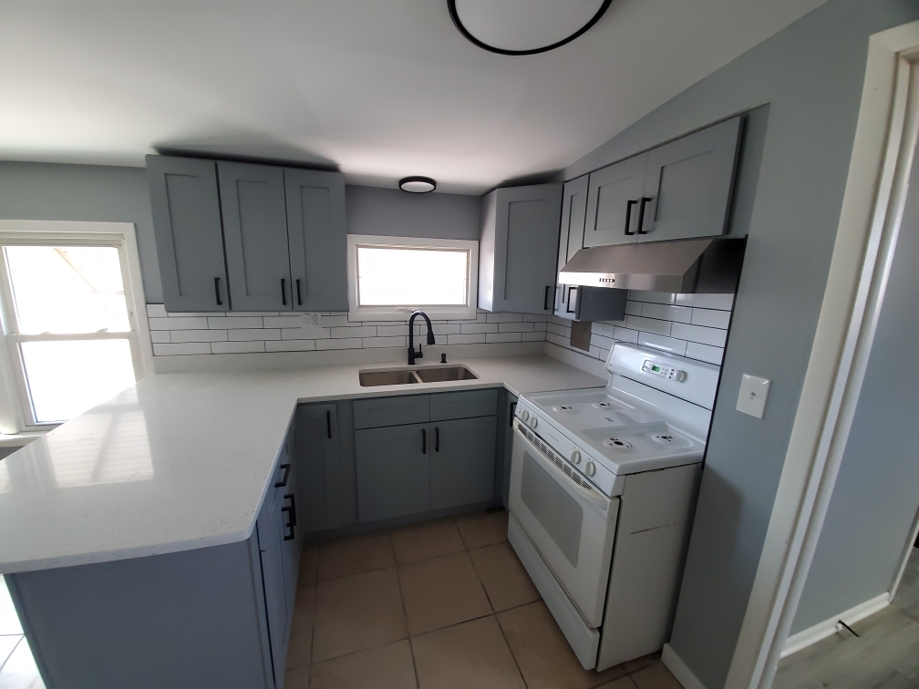 118 East North Avenue Addison, IL 60101 - Photo 36 of 50 a kitchen with a sink a stove a microwave and cabinets