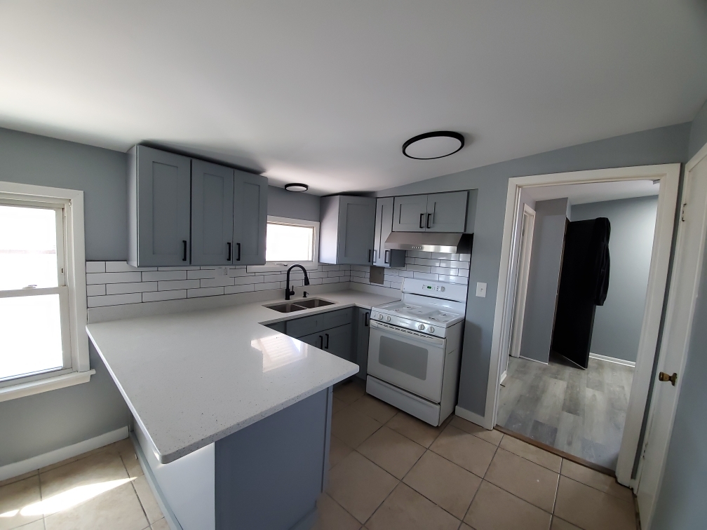 118 East North Avenue Addison, IL 60101 - Photo 37 of 50 a kitchen with stainless steel appliances granite countertop a sink stove and refrigerator