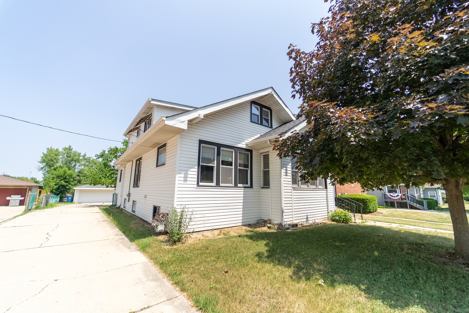 118 East North Avenue Addison, IL 60101 - Photo 45 of 50 a view of a white house next to a yard with big trees