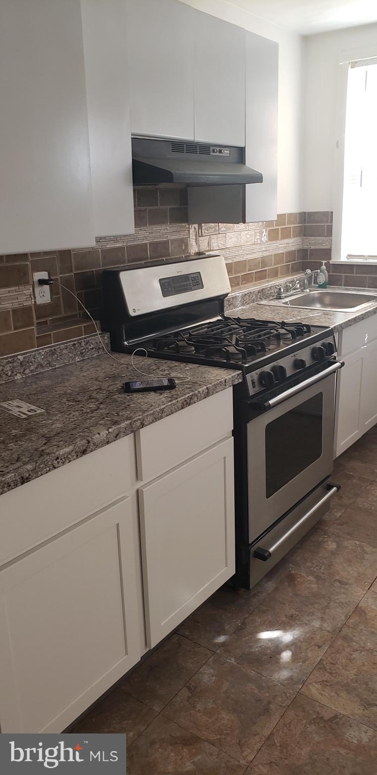 3054 Alabama Road Camden, NJ 08104 - Photo 8 of 25 a kitchen with granite countertop a stove and a sink