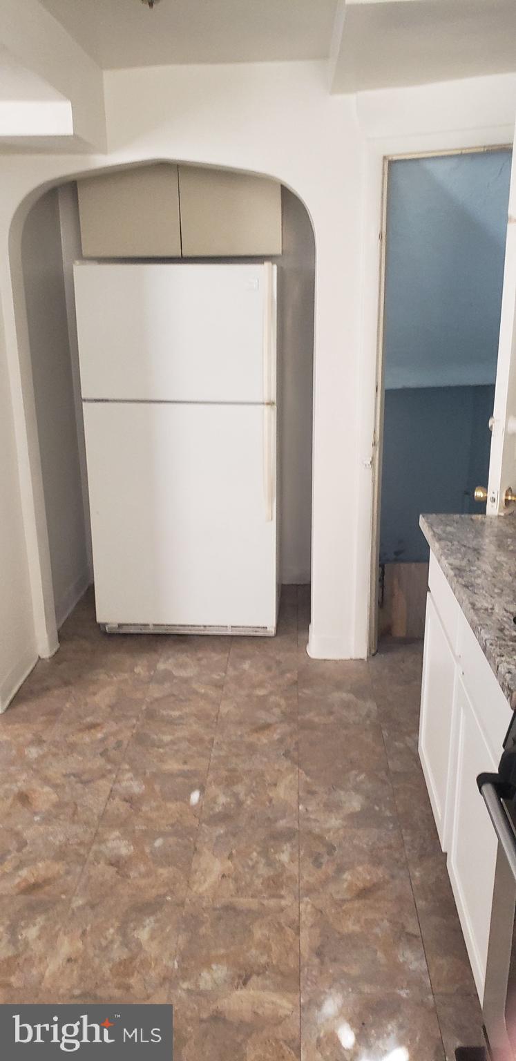 3054 Alabama Road Camden, NJ 08104 - Photo 9 of 25 a view of a refrigerator in kitchen and wooden floor