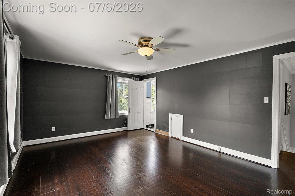 1051 Devonshire Road Grosse Pointe, MI 48230 - Photo 34 of 98 Spacious room featuring dark wood-finish flooring, dark-painted walls, and white trim