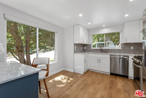 a kitchen with a sink stove and cabinets