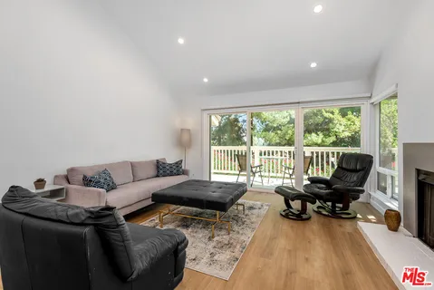 a living room with furniture and floor to ceiling window