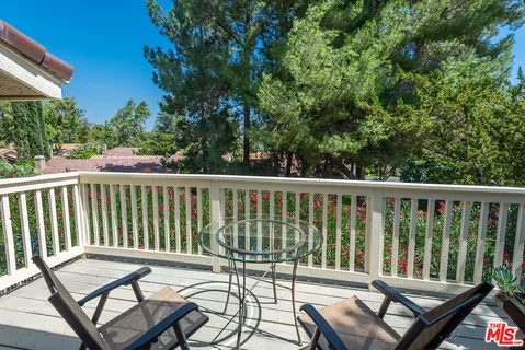 a view of a balcony with wooden floor