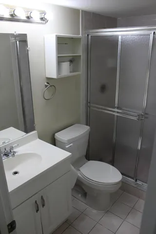 a white toilet sitting next to a bathroom sink