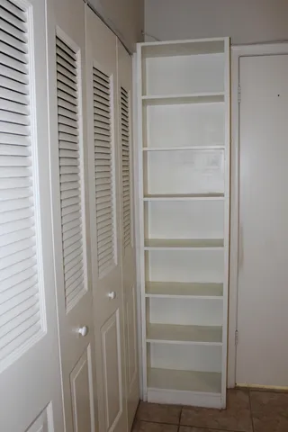 a view of walk in closet with empty racks