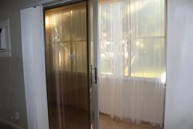 a bathroom with a glass door and windows