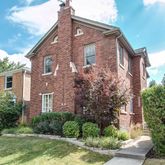 a brick building with trees in front of it