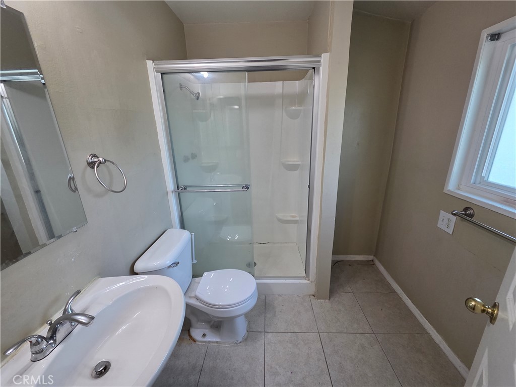 8317 Hudson Drive San Diego, CA 92119 - Photo 11 of 26 a white toilet sitting next to a bathroom sink