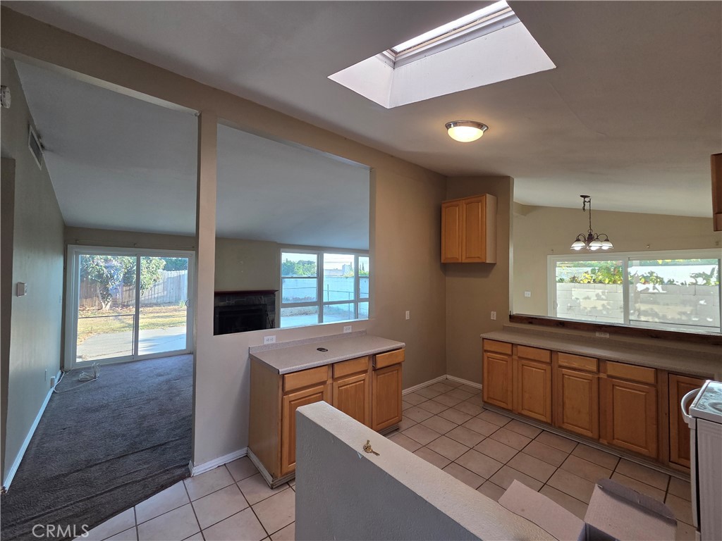 8317 Hudson Drive San Diego, CA 92119 - Photo 3 of 26 a kitchen that has a sink and a stove in it