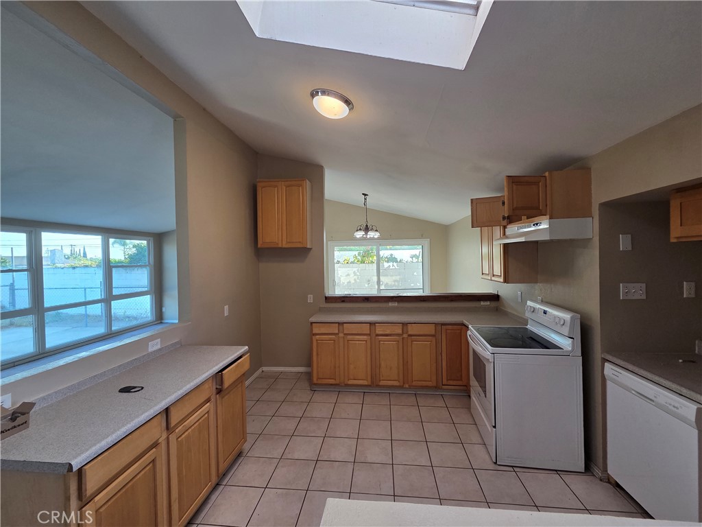 8317 Hudson Drive San Diego, CA 92119 - Photo 4 of 26 a kitchen with stainless steel appliances granite countertop a sink and a stove