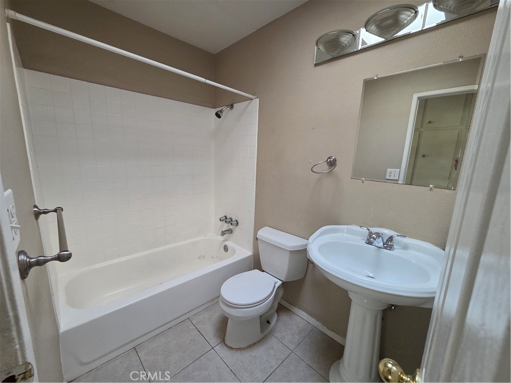 8317 Hudson Drive San Diego, CA 92119 - Photo 9 of 26 a bathroom with a sink a toilet and a bathtub