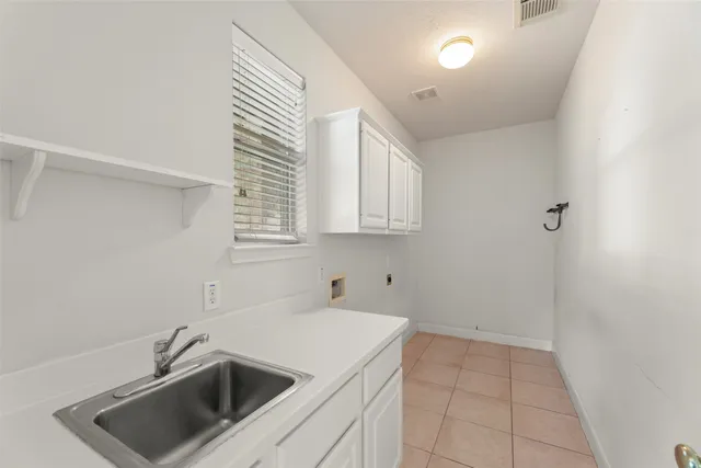 a kitchen that has a sink and a stove top oven