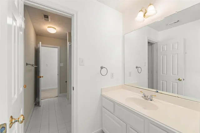 a bathroom with a sink a mirror and a vanity