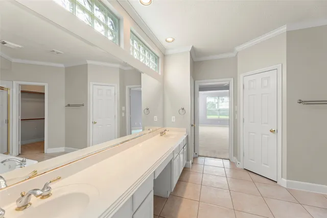 a spacious bathroom with a granite countertop sink and a mirror