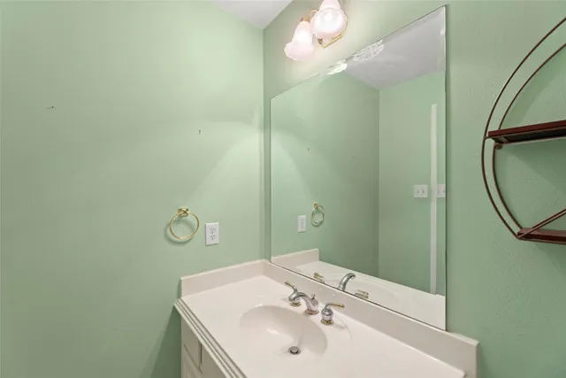 a bathroom with a sink a mirror and vanity