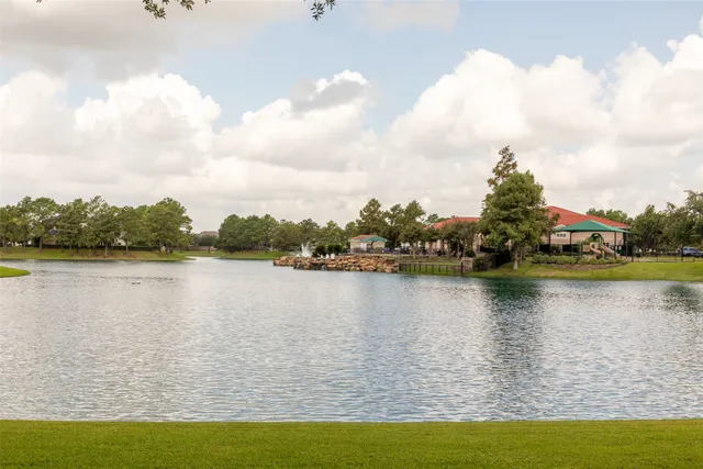 a view of a lake with houses in the back