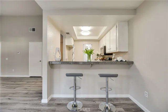a view of living room with furniture and wooden floor