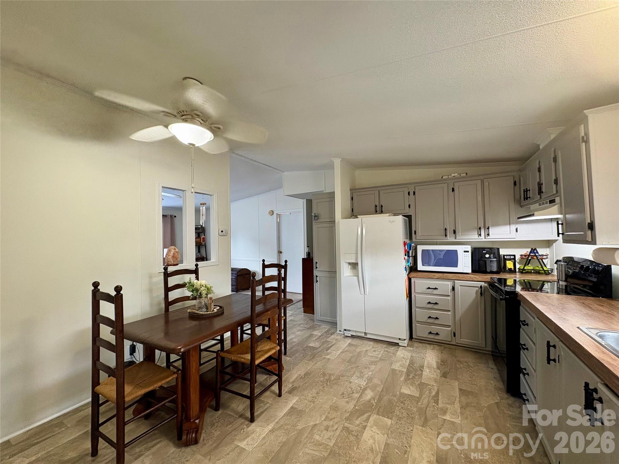 3422 Edwards Road Wingate, NC 28174 - Photo 14 of 31 a kitchen with refrigerator and chairs