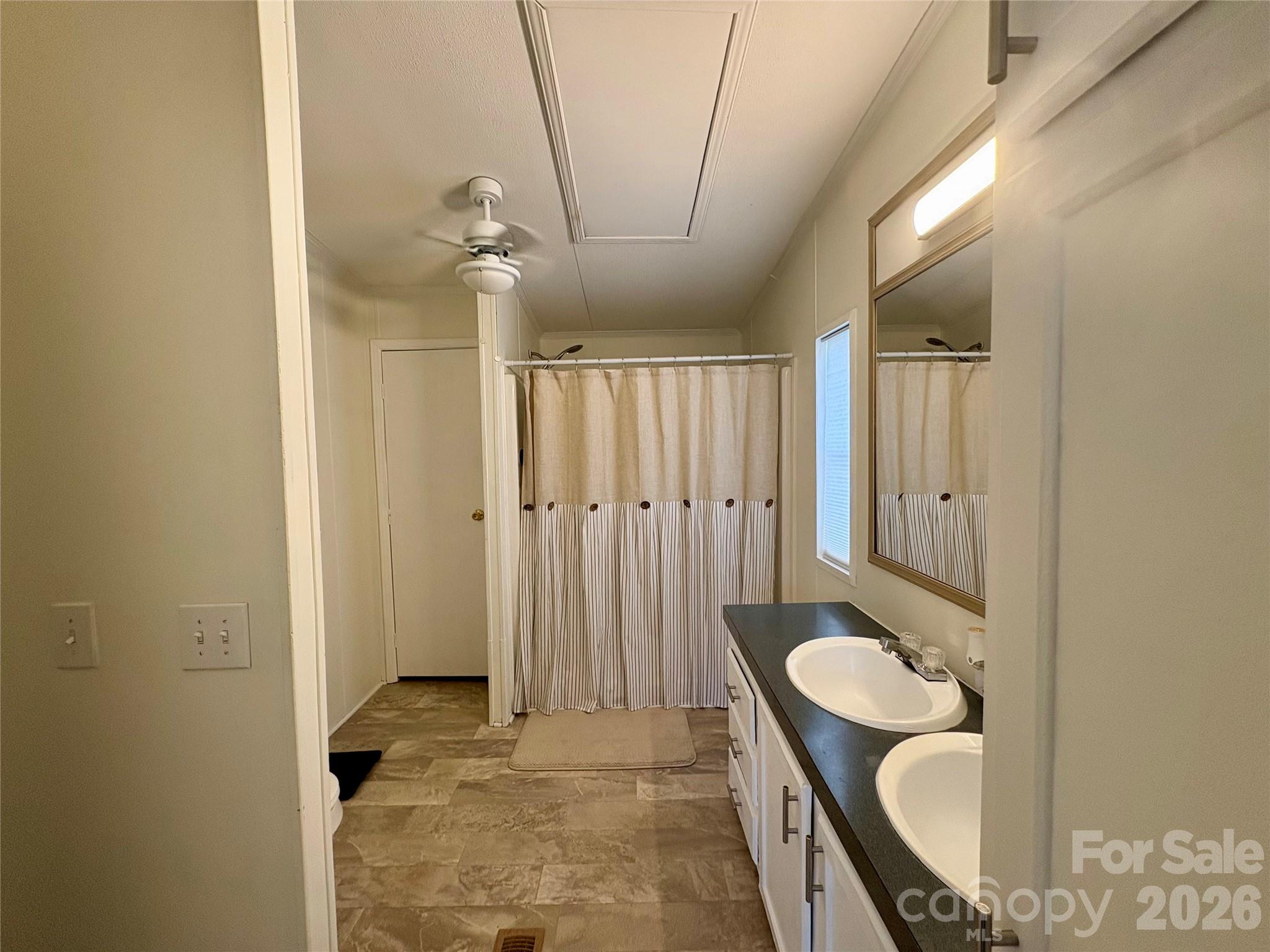 3422 Edwards Road Wingate, NC 28174 - Photo 23 of 31 a bathroom with a granite countertop sink a mirror and a shower