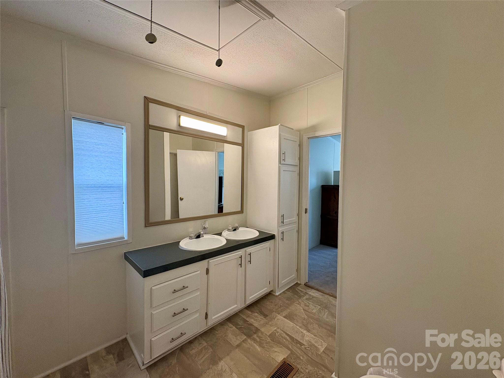 3422 Edwards Road Wingate, NC 28174 - Photo 25 of 31 a spacious bathroom with a granite countertop sink and a mirror