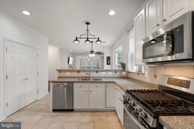 a kitchen with a sink stove and cabinets