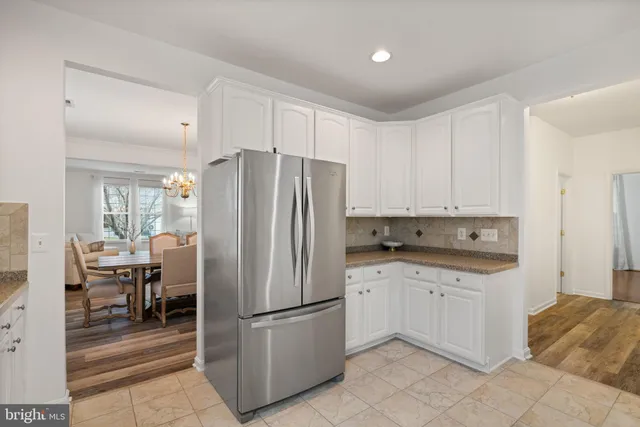a kitchen with stainless steel appliances granite countertop a refrigerator sink and cabinets