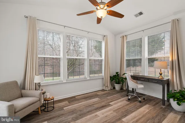 a view of a livingroom with workspace and a window