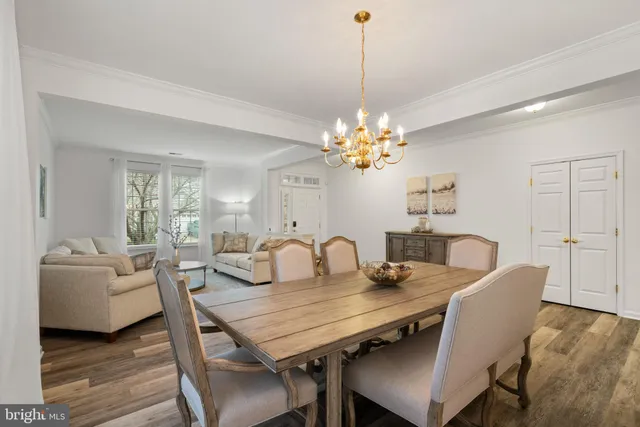 a view of a dining room with furniture wooden floor and chandelier