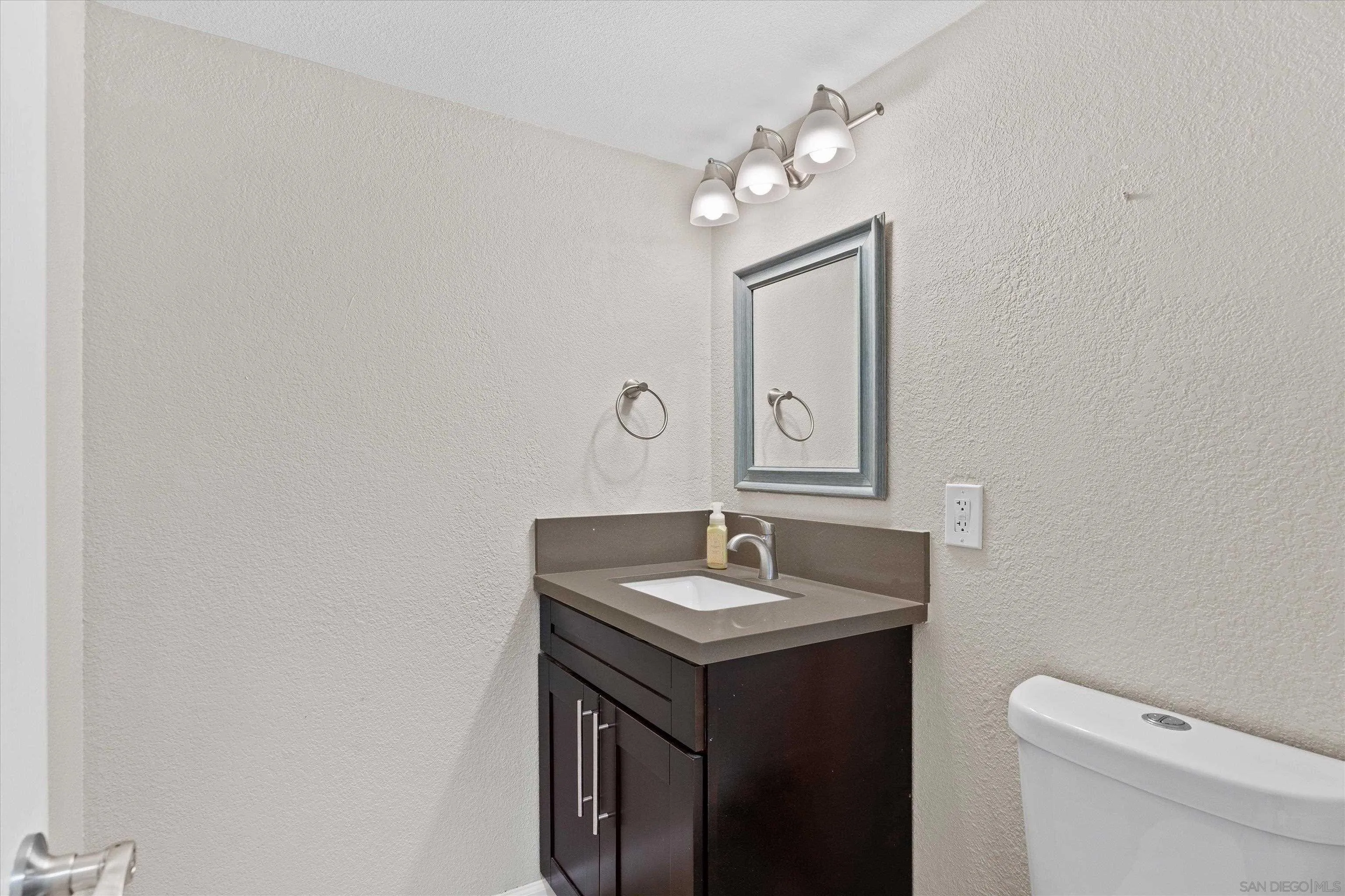 5636 Boot Way Oceanside, CA 92057 - Photo 14 of 36 a bathroom with a sink vanity and a mirror