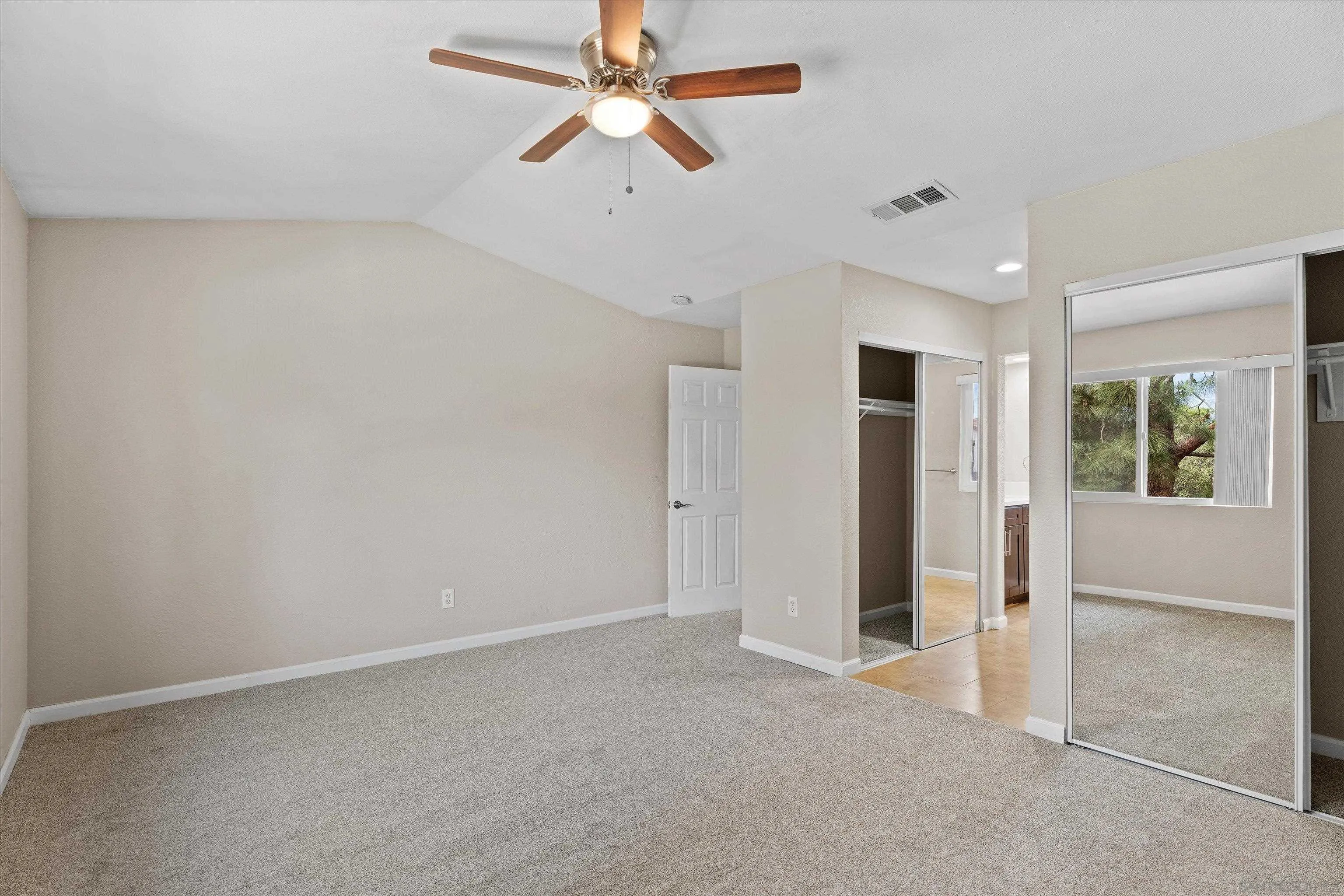 5636 Boot Way Oceanside, CA 92057 - Photo 17 of 36 an empty room with closet and a ceiling fan
